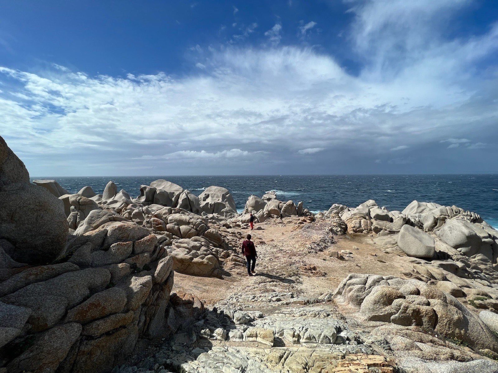 Wind-sculpted granite boulders of Capo Testa, with the sea behind