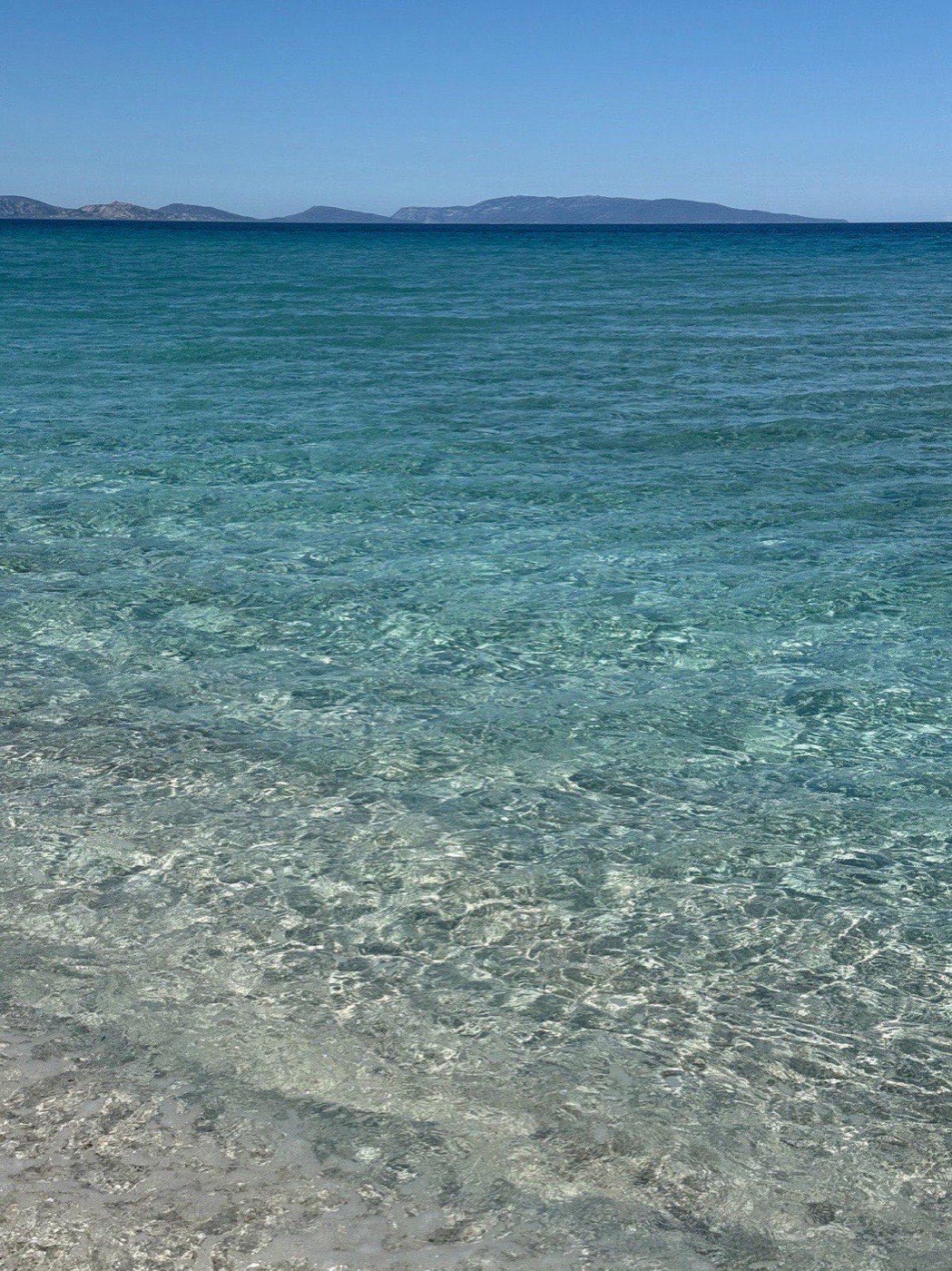 Clear shallow water at the edge of Le Saline beach