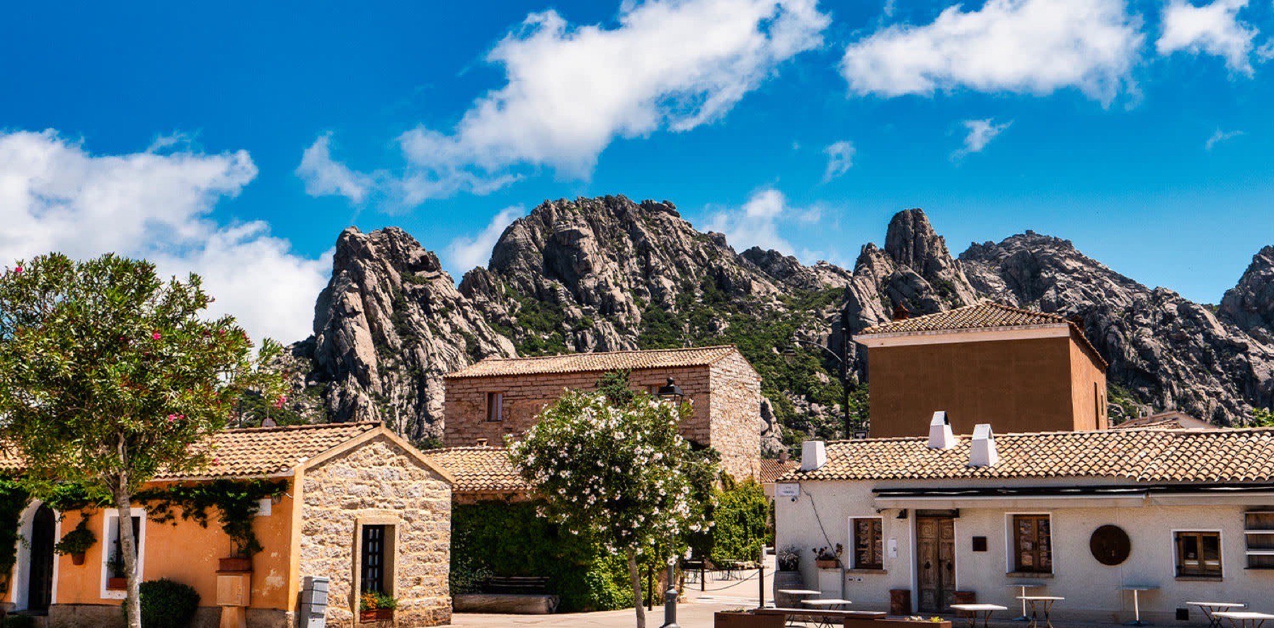 Stone houses of San Pantaleo with the jagged granite peaks of the Gallura hills behind